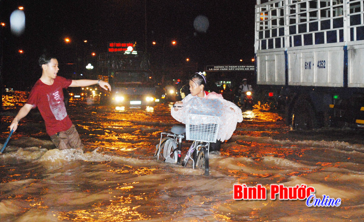 Nước chảy siết khiến em nhỏ (trong hình) không thể về nhà sau giờ học 