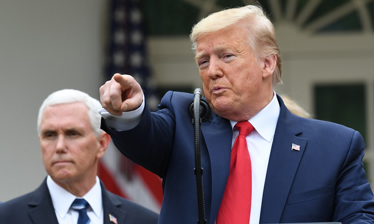 Tổng thống Mỹ Donald Trump (bên phải) và Phó tổng thống Mike Pence (bên trái) trong cuộc họp báo về Covid-19 tại Nhà Trắng ngày 13/3. Ảnh: AFP.